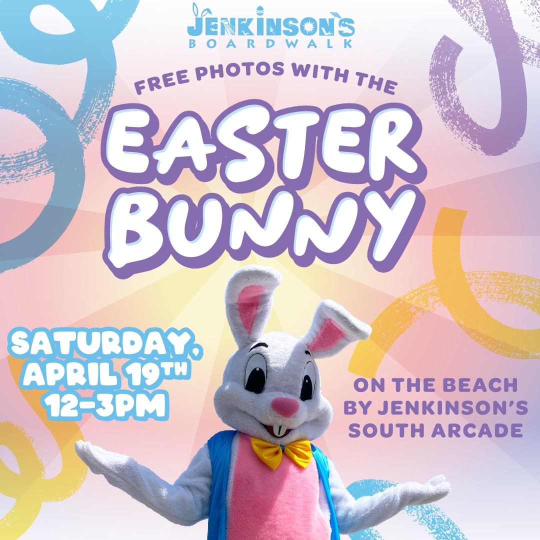 A friendly Easter Bunny mascot in a pink and blue outfit with a yellow bow tie poses on the beach, promoting free photos at Jenkinson's Boardwalk on Saturday, April 19th, from 12 PM to 3 PM.