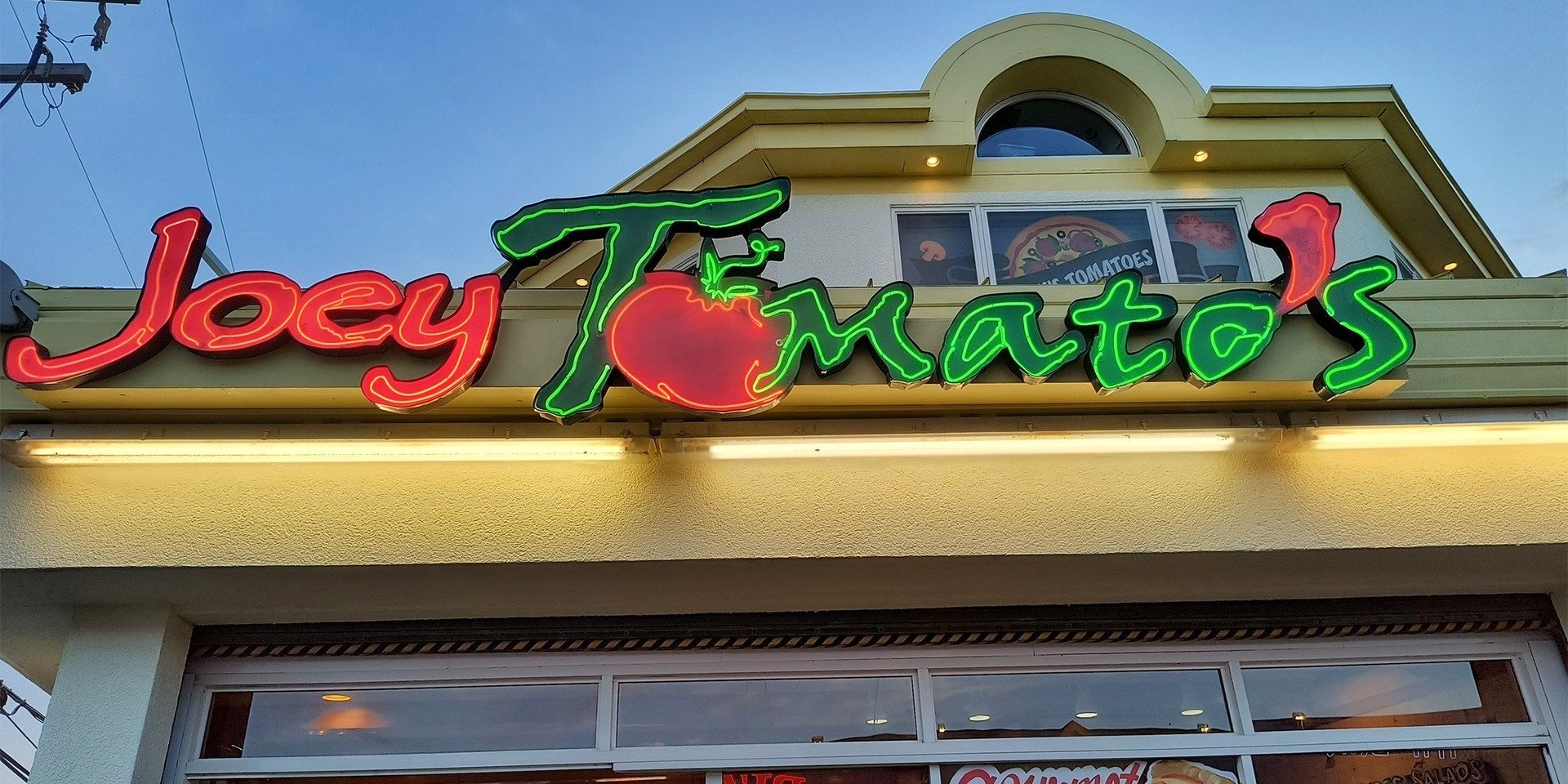 A restaurant named Joey Tomato's with a prominent sign displaying the name.