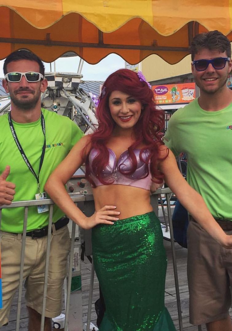 Girl dressed as Princess Ariel with two employees by each side on Jenkinson's Boardwalk.